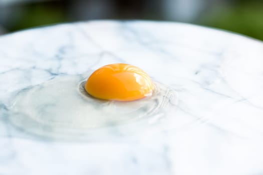 egg yolk on marble - recipe ingredients and homemade cooking styled concept