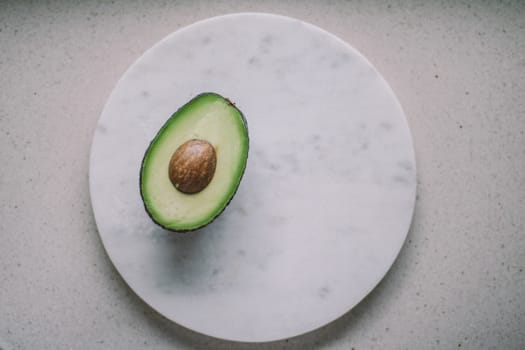 avocado on marble table - organic vegetables and healthy eating styled concept, elegant visuals