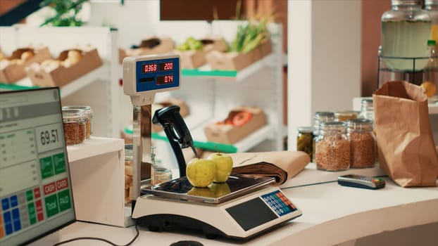 Local farmers market cash register with electronic scale used to sell fresh homegrown organic produce and healthy additives free bulk products. Zero waste small business store selling bio food.