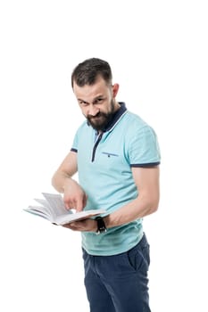 Image of bearded man looks at camera while shows the book