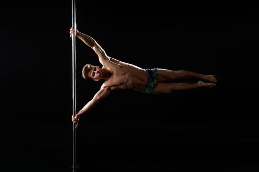 Male pole dance. Image of dancer with strained face