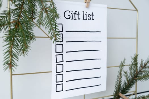 Preparation for winter holidays. GIFT LIST text on paper note. Celebration gifts and presents preparing Natural zero waste homemade Christmas decor. Happy new year concept.