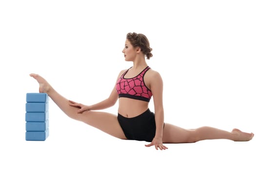 Gymnastics. Woman exercising with bricks for stretching