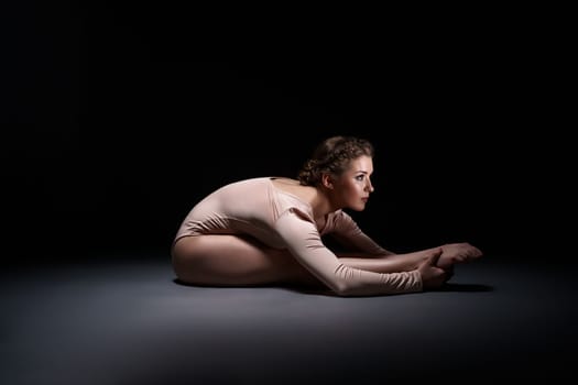 Studio photo of purposeful gymnast training, on gray background