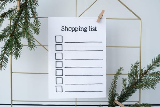 Preparation for winter holidays. SHOPPING LIST text on paper note. Celebration gifts and presents preparing Natural zero waste homemade Christmas decor. Happy new year concept.