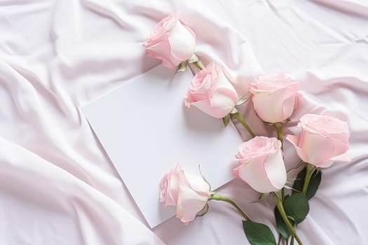 Floral composition. Pink flowers on white fabric. Flat lay, top view, copy space.