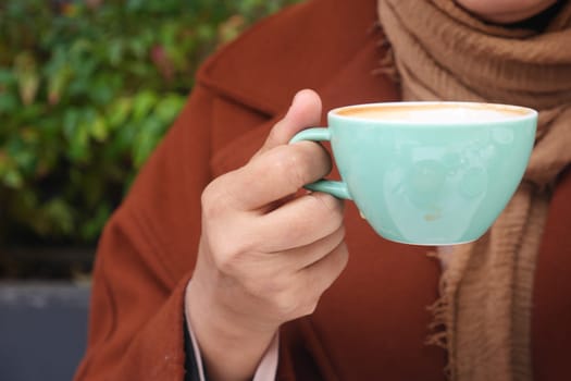 women holding a coffee cup .