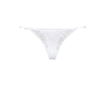 Embroidered White Thong on Pale Brunette A white thong with delicate embroidery along the waistb. Woman lingerie isolated on transparent background