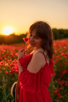 Woman poppy field red dress sunset. Happy woman in a long red dress in a beautiful large poppy field. Blond stands with her back posing on a large field of red poppies.