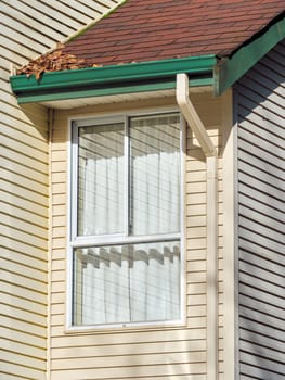 Window and roof of residential house submodule on sunny day.