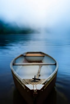 A Rustic Old Rowboat Beside On A Misty Lake At Dawn, With Shallow Focus And Copy-Space