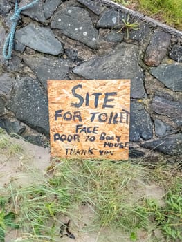 Sign explaining where to find the toilet at Portnoo harbour - County Donegal, Ireland