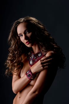 Chic. Portrait of beautiful naked woman posing in jewelry