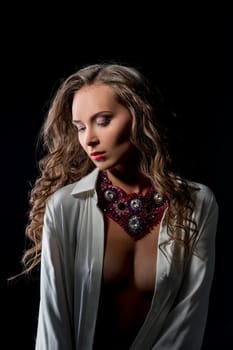 Glamour. Studio image of sensual woman posing in jewels