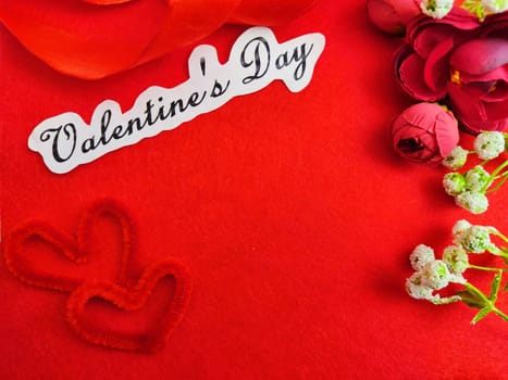 Valentine's Day concept celebration, congratulation. Red greeting Card with flower, Satin ribbon for Background, texture, place for text, copy space