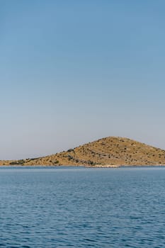 Sea water and hills on horizon under clear blue sky, Dugi Otok island in Adriatic Sea, Croatia