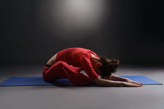 Fitness. Studio photo of pretty girl warming up on mat