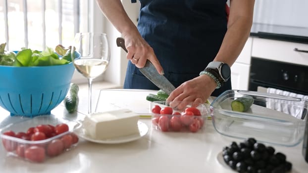 Woman'S Hands Are Slicing Cucumber For Greek Salad With A Glass Of White Wine Nearby