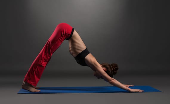 Image of lovely caucasian woman practising yoga in studio