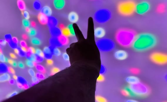 Hand gesture silhouette on a colorful background reaching out, saying hello, and show number represent for multimedia content creation