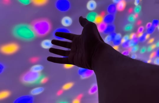 Hand gesture silhouette on a colorful background reaching out, saying hello, and show number represent for multimedia content creation