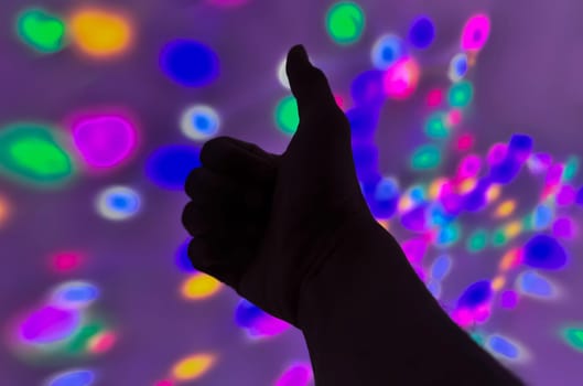 Hand gesture silhouette on a colorful background reaching out, saying hello, and show number represent for multimedia content creation