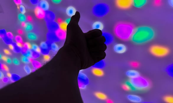 Hand gesture silhouette on a colorful background reaching out, saying hello, and show number represent for multimedia content creation