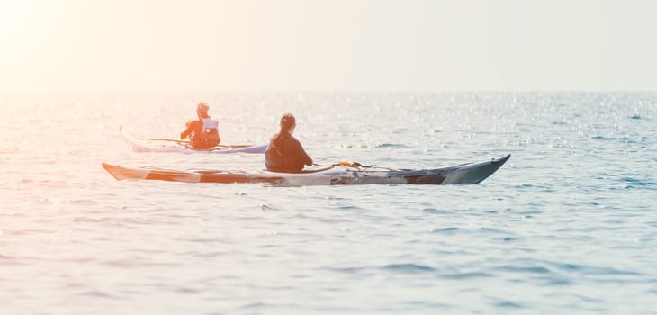 Happy smiling woman in kayak on ocean, paddling with wooden oar. Calm sea water and horizon in background