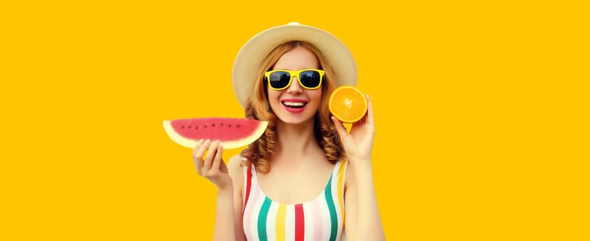 Summer portrait of happy young woman with fresh slice of watermelon and orange fruits in straw tourist hat, sunglasses on yellow background