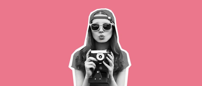 Stylish happy young woman photographer taking picture on film camera blowing a kiss on pink background, magazine style