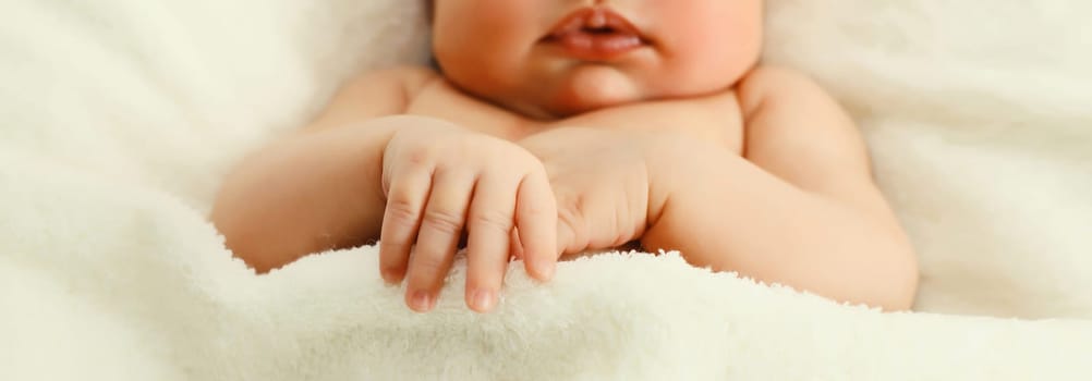 Close up portrait of infant sweet sleeping lying on white bed at home