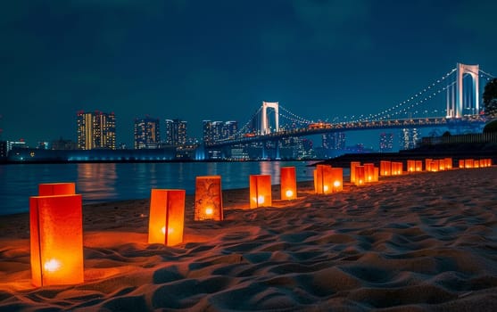 A dusk scene captures glowing candles on sandy beach leading the eye to an urban skyline and a majestically lit bridge. Japanese Marine Day Umi no Hi also known as Ocean Day or Sea Day.