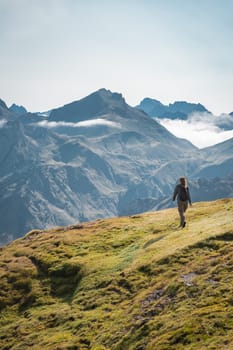 Young Woman With A Backpack on The Top Of a Beautiful wild Landscape. High quality photo