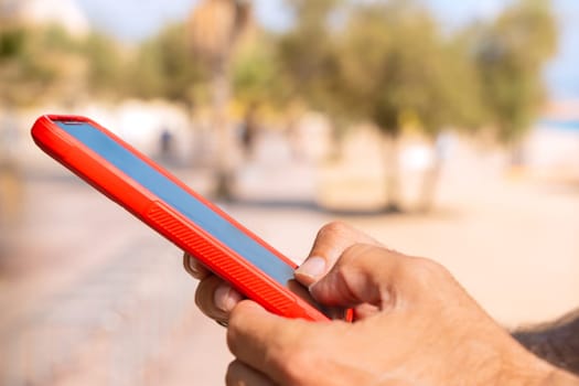 man hands typing on phone browsing telephone on social media.