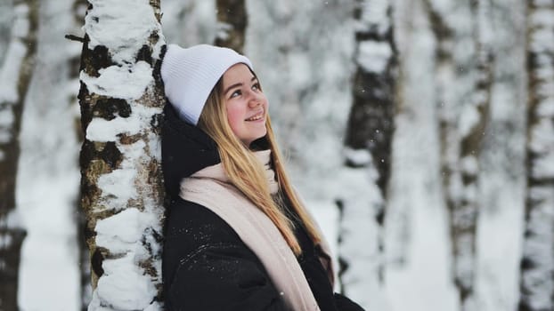 Portrait of a girl in winter in a birch forest