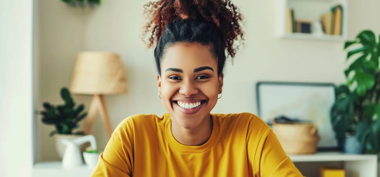 Portrait of happy smiling african young woman looking at camera 20s black girl listening on laptop video call in room at home, toothy smile