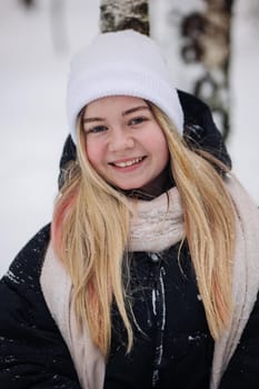 Portrait of a teenage girl in winter in the woods