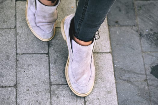 a soft leather slipper or shoe, strictly one without a separate heel, having the sole turned up on all sides