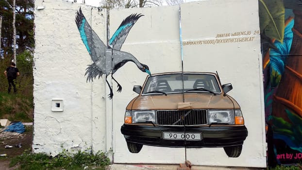 Stockholm, Snosatra, Sweden. May 12 2024. Spring beast. Graffiti exhibition on the outskirts of the city. Car and bird.