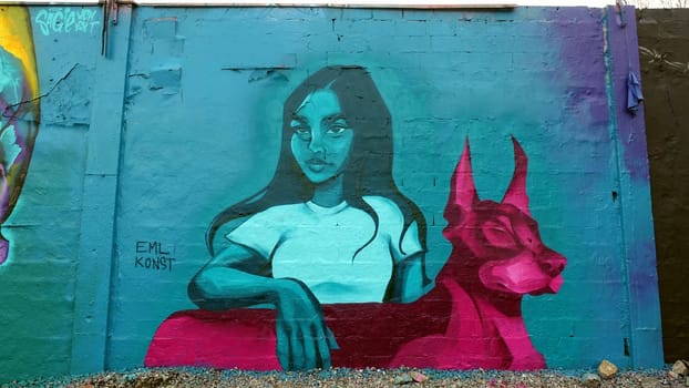 Stockholm, Snosatra, Sweden. May 12 2024. Spring beast. Graffiti exhibition on the outskirts of the city. Girl and dog.
