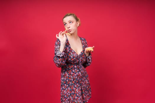 Young beautiful slender female eating a french fries. Concept of un healthy fat junk and healthy food