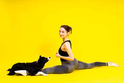 A beautiful sport female with border collie in a studio