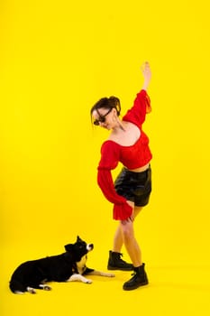 A beautiful sport female with border collie in a studio