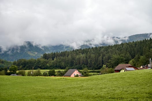 Mountain chalets and Carpathians mountain ridge on a cloudy foggy day. Travel destinations. Tourism and trip concept. Rural scene. Discovering the beautiful nature in Slovakia