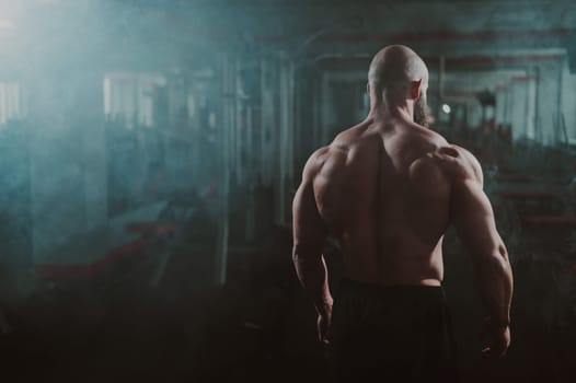 Caucasian bald man posing in the gym