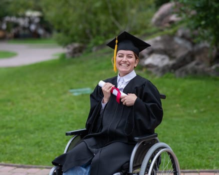 Happy caucasian woman in a wheelchair holding her diploma outdoors