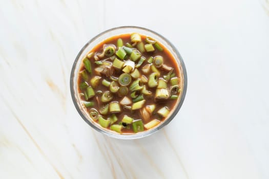Spring Onion Coffee Or Scallion Coffee, Popular Beverage In China. Top View Glass Of Drink, Cappuccino Or Latte With Onions On Granite Table. Horizontal Plane High quality photo