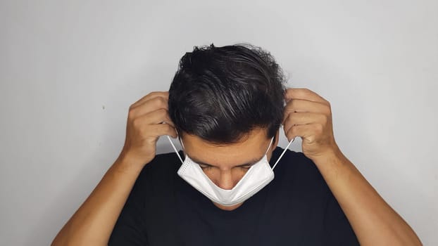 a young guy in a protective mask protects himself from coronavirus, a pandemic of the Chinese virus. Ncov-2019.