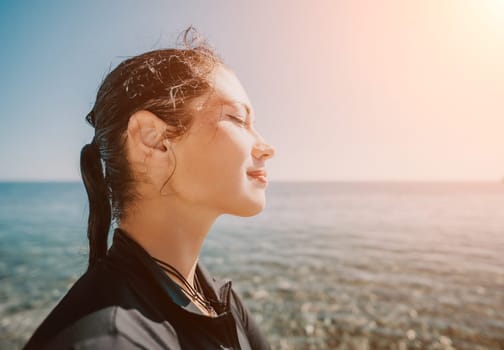 Woman travel sea. Young Happy woman posing on a beach near the sea on background of volcanic rocks, like in Iceland, sharing travel adventure journey