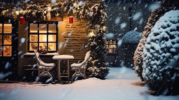 Christmas in the countryside, cottage and garden decorated for holidays on a snowy winter evening with snow and holiday lights, English country styling inspiration